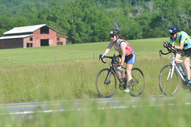 Amanda biking in the Chattanooga 70.3 half Ironman race in May 2026.